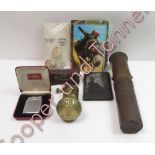 A colibri lighter, along with postcards, pepper mill and other items
