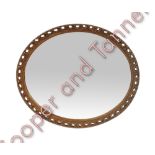 A decorative oval gilt framed wall mirror with bevelled plate 69cms x 59cms