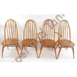 A set of four (three standard on carver) Ercol light wood stick back chairs