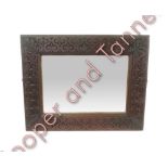 A rectangular wall mirror having bevelled plate and in heavy carved wood frame, 64cms x 81cms