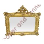 A decorative Rococo style gilt wood wall mirror 86cms high 94cms wide max