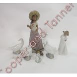 Three Nao figures of geese; a figure of a young girl wearing a nightgown; figure of a young girl