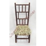 A stained beech nursing chair with bobbin turned frame and upholstered seat