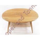 An Ercol lightwood oval coffee table 43cms high