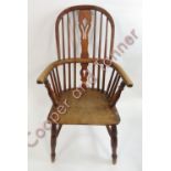 A Windsor farmhouse chair with pierced splat back, curved arm rests and turned supports