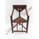 A late 19th/early 20th Century oak turners chair having foliate carved back rail, bobbin turned