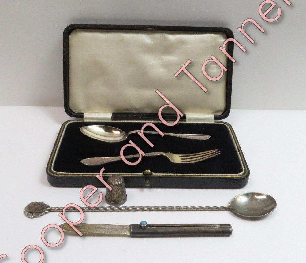 A cased silver spoon and fork christening set, Birmingham 1930; with a silver retractable small