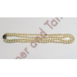 A uniform two row cultured pearl necklace, the 63 and 59 pearls of approximately 6.5/7.4 mm