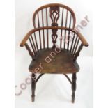 A 19th Century Windsor chair with pierced splat, curved yew wood top rail and armrests, elm seat,