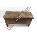 A small oak coffer, with single plank lid, simply carved front and on side plank supports, 51cms