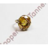 A single yellow stone ring, indistinct marks, finger size J, 5 g gross, cased