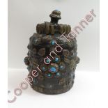 An oriental carved wooden jar and cover, with decorated in relief with brass mounts, 22cm high