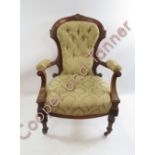 WITHDRAWN A Victorian upholstered open arm chair with decorative walnut frame