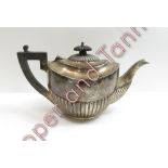 A silver tea pot, marks worn, of oval half gadrooned design, 23 cm long, 329 g (10.5 troy ozs)