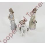 A Lladro figure of a seated dog “New Friend” in box; Lladro figure of a young girl Cathy and another