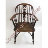 A 19th Century Windsor chair with pierced splat, curved yew wood top rail and armrests, elm seat,