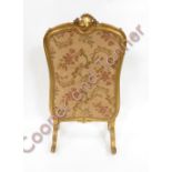 A 19th Century gilt wood framed fire screen in Rococo style with later central machine woven