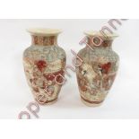 A pair of Japanese satsuma baluster vases with painted decoration of children and adults in