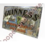 A Guinness advertising wall mirror, with gilt, black and coloured lettering and shamrock and harp