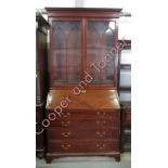 An early 19th Century mahogany bureau bookcase, the upper section with dentil cornice, astragal