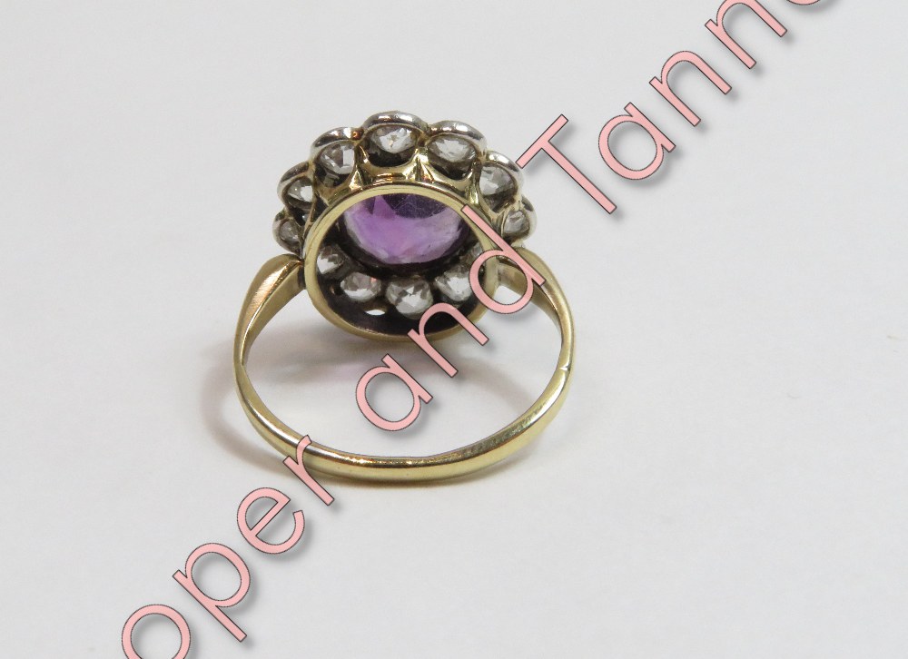 An amethyst and diamond cluster ring, unmarked, the oval cut amethyst enclosed by twelve old - Image 2 of 2
