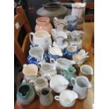 LARGE QUANTITY OF CERAMIC JUGS & A PIECE OF BRASS