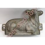 A white metal two piece food mould modelled as a recumbent lamb, 31cms wide max (later holes drilled