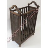 An early 20th Century oak and cane stick stand of rectangular form with original metal drip trays