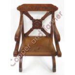 A 19th Century carved oak ecclesiastical chair, the curved cresting rail with deeply carved