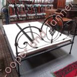 A late 19th/early 20th Century painted metal bed, the head and foot of openwork curved design with