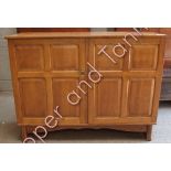 An Art Deco light oak cupboard, with fielded panel doors, cutlery drawer and adjustable shelves.