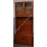 A G Plan teak side cabinet the upper section fitted with pair of glass doors and with cupboard to