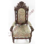 A Jacobean style oak carver chair, the tall back with Green Man mask and spiral twist pillars