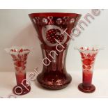 A large ruby flash glass vase of flared form and engraved with stag, trees and castle, 30.5cms