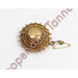 A Victorian unmarked gold brooch, of circular outline, 3.3 cm diameter, 11 g gross