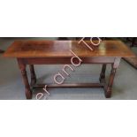 A small oak refectory style table with single plank top and on tapering turned cylindrical