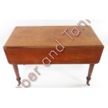 A Victorian mahogany Pembroke table fitted with a single drawer and on tapering turned cylindrical