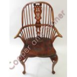 A reproduction Windsor chair having pierced splat back, shaped elm seat and cabriol front supports