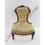 A Victorian walnut framed nursing chair with gold brocade upholstery