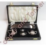 A miniature silver four piece tea and coffee service, on a tray, in a fitted case, maker DSM, London