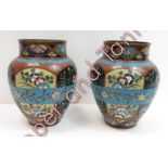 A pair of Japanese cloisonné vases of baluster form decorated with panels of blossom and songbirds
