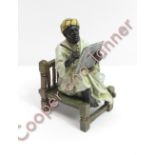 A reproduction cold painted Bergmann figure of a North African scribe seated on a low chair, 10.5cms