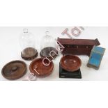 A quantity of modern Oriental hardwood stands; burr wood bowls; glass domes on bases and other