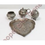 A three piece metalware cruet set on a small tray, probably Indian, circa 1930, unmarked, all