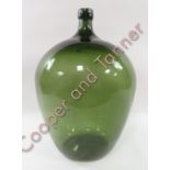 A large green glass carboy approx. 66cms high