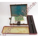 Mah Jong - a case of tiles and counters with booklets of rules and a box of Mah Jong wings