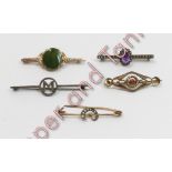 A jade set bar brooch, indistinctly stamped; a seed pearl set bar brooch; an amethyst cabochon and