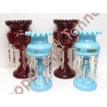 A pair of 19th Century ruby glass lustres with painted decoration 31cms high together with a pair of