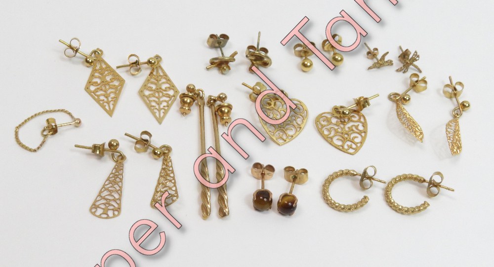 A collection of ten pairs of earrings and a single earring
