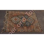 A Middle Eastern wool rug the central panel with three large medallions and smaller medallions